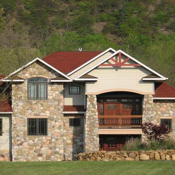 Custom Home In Edinburg VA This home was built with craftsman details. From the deep overhangs on the roof to the tapered stone columns, this house has