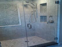 Custom Marble & Granite Shower Here we've blended elements of marble tile, Granite slabs, and glass tile accents to create a shower fit for a king!