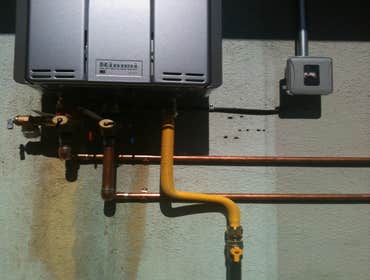 On -Demand water heater install ( Ours vs. Theirs ) Removal of tank-type water heater, run copper lines and electrical supply from attic, resize gas su