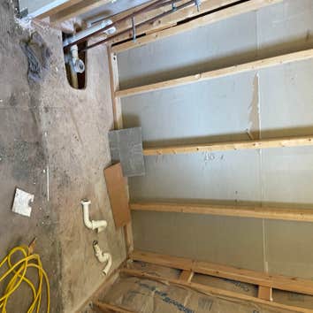 Small bathroom after demo of old bathtub stripped