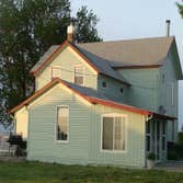 Exterior Painting from Pro West Painting Two story house painted in three color scheme. Light Green body with cream and red trim.