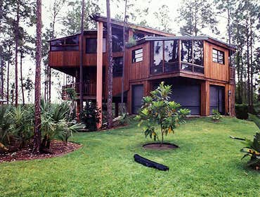 Pereira Residence Built using local tide water red Cyprus sinker logs for structure, the roof cupola allows the home to breathe as if a pair of lungs, 