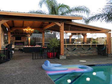 Outdoor kitchen Framed 450 sqft outdoor structure. Big timber metal roofing. Also built t.v./fireplace wall, counter tops for eating, wine fridge, stor
