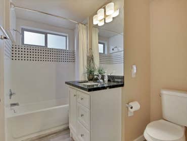 Bathroom remodel adding a window, tile, cabinet and granite countertop and laminate flooring