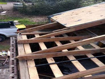 Photos by Service Restoration Pros LLC #1 A tree fell through the roof of this 3 bedroom house during Hurricane Ida. It left several gaping holes and a