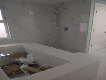 Photos by Subias Granite & Marble #4 MSI surfaces large format 24*48 porcelain tiles shower walls and floors plus baseboards. MSI surfaces Antique Whit