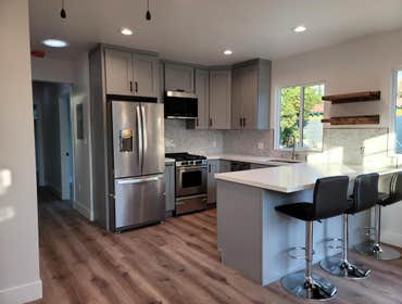 Kitchen & Bathroom remodel This kitchen and bathroom remodel in Cupertino features prefabricated cabinetry, quartz countertops, new flooring, and elega