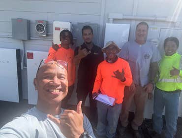 Customer with the crew! Happy to have his Powerwalls installed right before the storm!