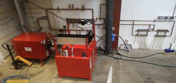 Photo(s) from Radiant Floor Heating Specialist Commercial boiler room with Lochinvar boilers and piping, Trucking companies Clean Burn waste oil burnin
