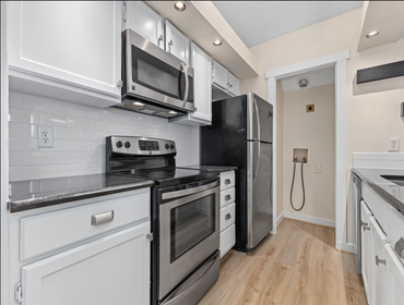 Photos by Sunlara #1 Home renovation including bathroom tub, tile surround, paint, baseboard replacement, flooring replacement, custom cabinetry, and s