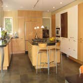 Modern Kitchen Remodel This modern architect's kitchen is a combination of Beech wood, high gloss white, and aluminum & glass. The natural slate floor