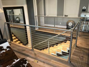 Photos by Brainz & Brawn Structures Inc #1 Stainless Steel bar handrail.. multi-tier stainless railing for interior staircase and basement access.