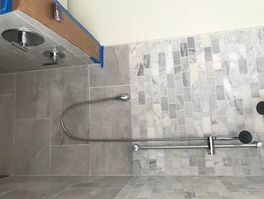 New bathroom with valves located on small wall so u don’t get wet while turning it on
