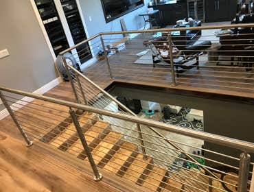 Photos by Brainz & Brawn Structures Inc #1 Stainless Steel bar handrail.. multi-tier stainless railing for interior staircase and basement access.