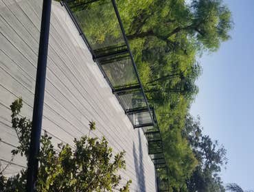 Photos by Remo Construction #3 Deck by the pool. Trex premium floor (Island Mist), Aluminium and glass railings