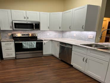 Photos by Tropical Building & Remodeling Inc #1 Completely removed old kitchen and end pony wall. Cut down pony wall to cabinet height and installed ro