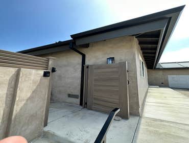 Angle-faced aluminum rain gutter and downspout installation.