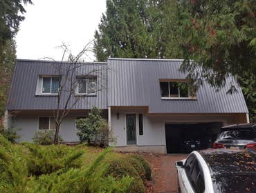 Reroof and reside. Replace old shingle shake roof. With new metal roof. Demo old lap siding. Replaced with Hardy panel siding.