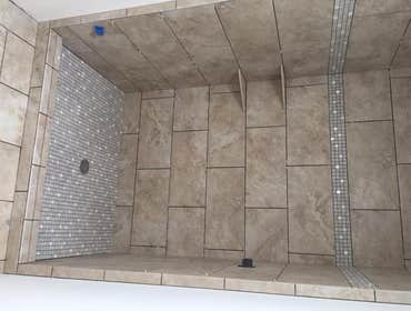 Showers & Bath Surrounds Here are a few separate projects...ranging from white subway tile to large format porcelain with either decorative bands or ni
