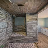 Bathroom Remodel Freshly remodeled bathroom with a lavishly designed and open shower plan You can get lost in there! The wood flooring and sink design 