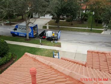 Photos from Popa Construction LLC Before & Afters of a soft wash roof cleaning and driveway and side walk cleaning.