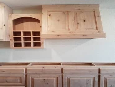 Custom built vent-a-hood, wine rack, and media shelf