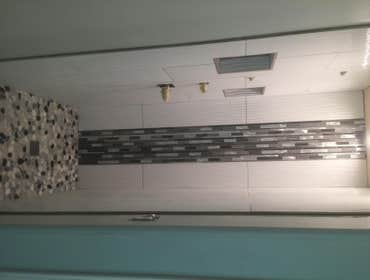 Photos from Cota Custom Tile Master bathroom custom shower 12"x36" ceramic tile with glass mosaic. The shower floor is riverstone. Custom niche inserts