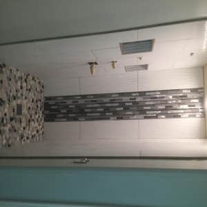 Photos from Cota Custom Tile Master bathroom custom shower 12"x36" ceramic tile with glass mosaic. The shower floor is riverstone. Custom niche...