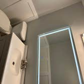 Photos by Goat Construction Group LLC #3 Total rehab of powder room with board & batten wall, LED mirror, tiled flooring, new toilet, vanity and fresh 