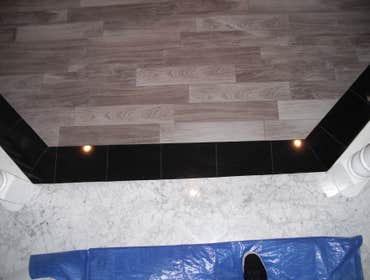 Photos by Floored #1 8 inch Galaxy Granite border.4 ix 24 inch Porcelian plank tile inlay.