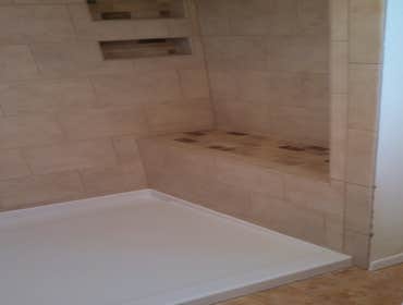 Shelton Master Bath High quality tile installation done atop a fiberglass shower pan. It has a bench, 2 shampoo inserts and 2 soap inserts. I thought t