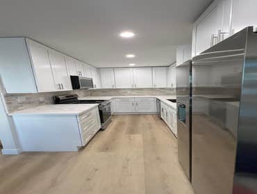 Photos by Eliteblvd Construction #20 Acomplete interior renovation featuring a redesigned kitchen, upgraded bathrooms, new flooring, custom cabinetry, 