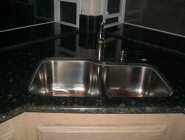 Kitchen Remodeling in H.B. Ca We replaced the Kitchen tiles , also put new granite counter tops and bathroom counter tops.