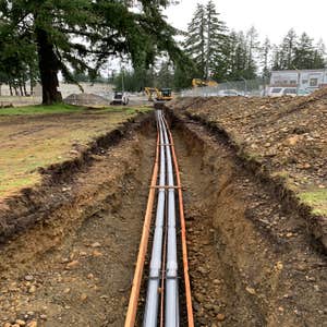 Photos by Top Grade LLC (Electrical) Excavation for electrical duct bank in poured concrete for high voltage power.