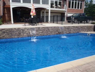 Clearwater Pools 18x37 Grecian Swimming Pool in Huntsville, AL 18x37 Greican with deck jets and custom retaining wall with waterfalls and custom coping