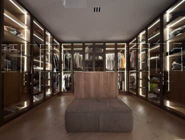 Walk-in closet Walk-in closet featuring cabinetry with durable plastic laminate interiors throughout. Storage is enclosed with aluminum-framed doors fi