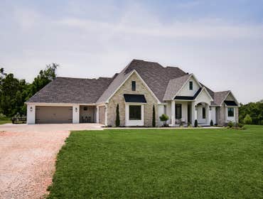 Highfill Custom Home 5000 sq. feet sitting on 10 acres with a four car garage, two outdoor living areas, and a pool.
