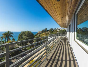 Trino Patio & Landscape Remodel Experience our completed patio project featuring stunning ocean views, sleek modern railings, and warm wooden accents, 