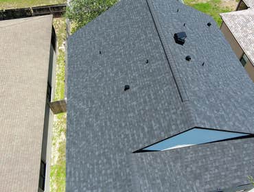 Photos by Steel Hammer Roofing and Construction LLC #31 Roof replacement on two-story home in Titusville using Owens Corning Onyx Black shingles and st