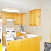 Camachos Custom Painting Project Drywall repair after kitchen backsplash removal. Cabinet refinishing for an updated design.