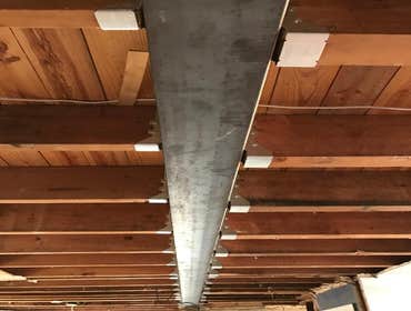 Remove supporting walls and install steel beam to create open concept
