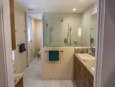 2013: Wood & Stone Modern Master Bath We reconfigured two full baths into one powder room and a larger master bath & closet suite combination. The area