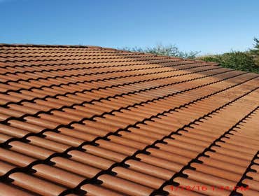 Photos from Popa Construction LLC Before & Afters of a soft wash roof cleaning and driveway and side walk cleaning.