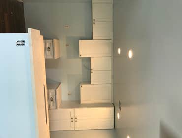 Kitchen remodel with brand new cabinets, recessed lights, back splash and flooring.