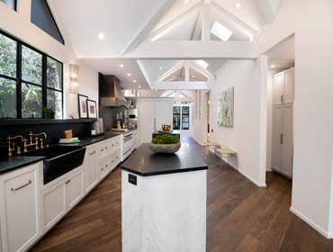 Architectural Kitchen Design This kitchen boasts two islands and soapstone countertops. It creates an inviting and highly functional space with warm to