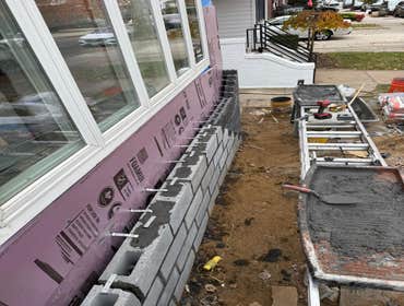Photos by Strong Innovative Structures Inc #1 Exterior brick veneer installation and front façade renovation. Installed new CMU block base with proper 
