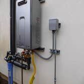 Tankless water heater installation Rinnai 9.4 tankless water heater, exterior installation on a slab foundation