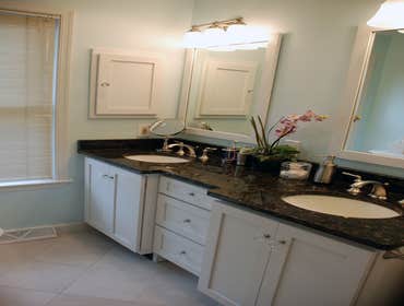 New master bathroom Old bath had single sink and little storage. New one is bright, airy and offers maximum use of square footage.
