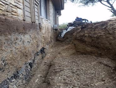 BACKHOE AND BOBCAT SERVICE DUG 10 FT DOWN TO ACCES FRENCH DRAIN