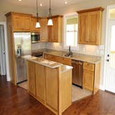 Riverside Retreat This custom home was designed for a magnificent front porch view of Libby Mountain to the south and the Little Red River flowing in t